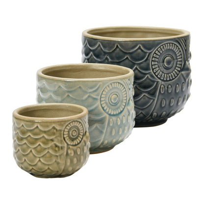 side view of 3 sizes and colors of owl planter in a row on a white background.