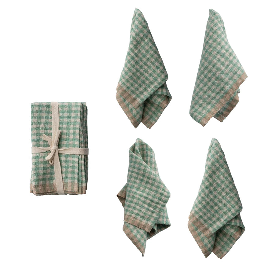 Set of aqua and beige gingham napkins draped on a white background