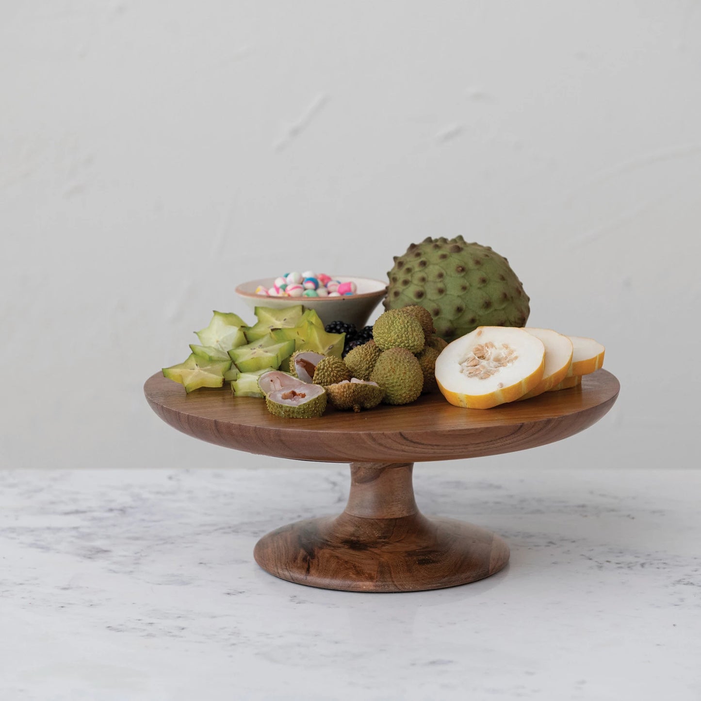 side view of wooden pedestal with fruit on it.
