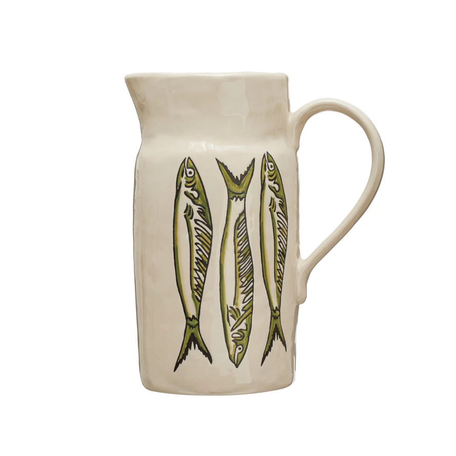 cream colored pitcher with 3 green fish vertically across the front.