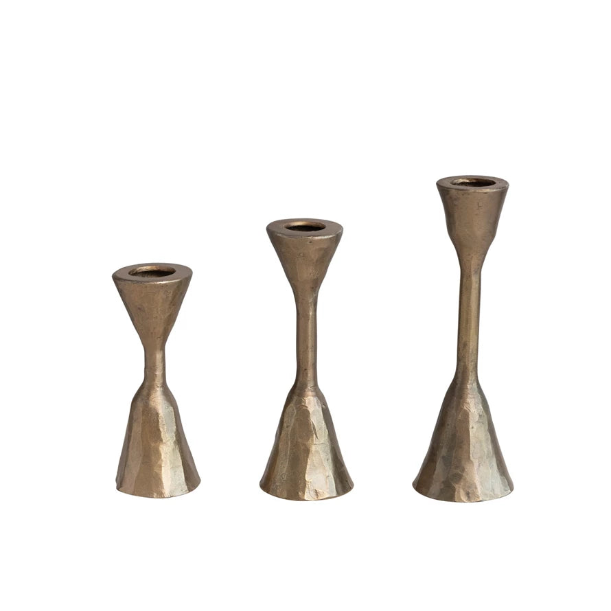all three sizes of antique brass finished hand forged iron taper holders displayed against a white background