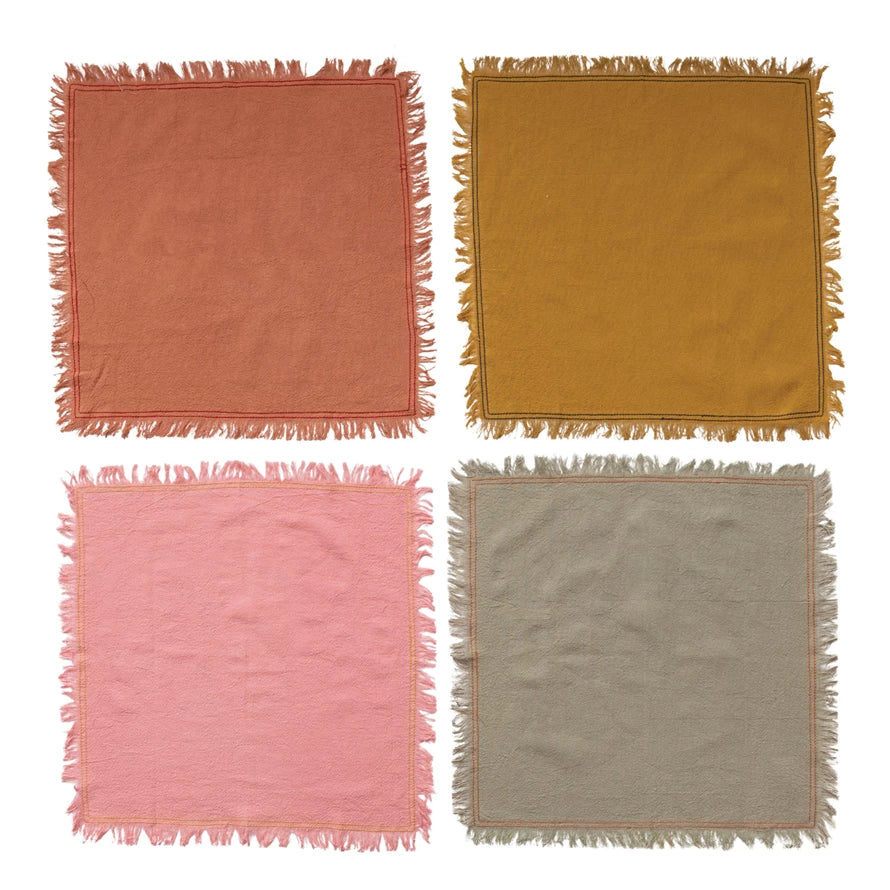 all four color of cotton napkins with fringe displayed open on a white background