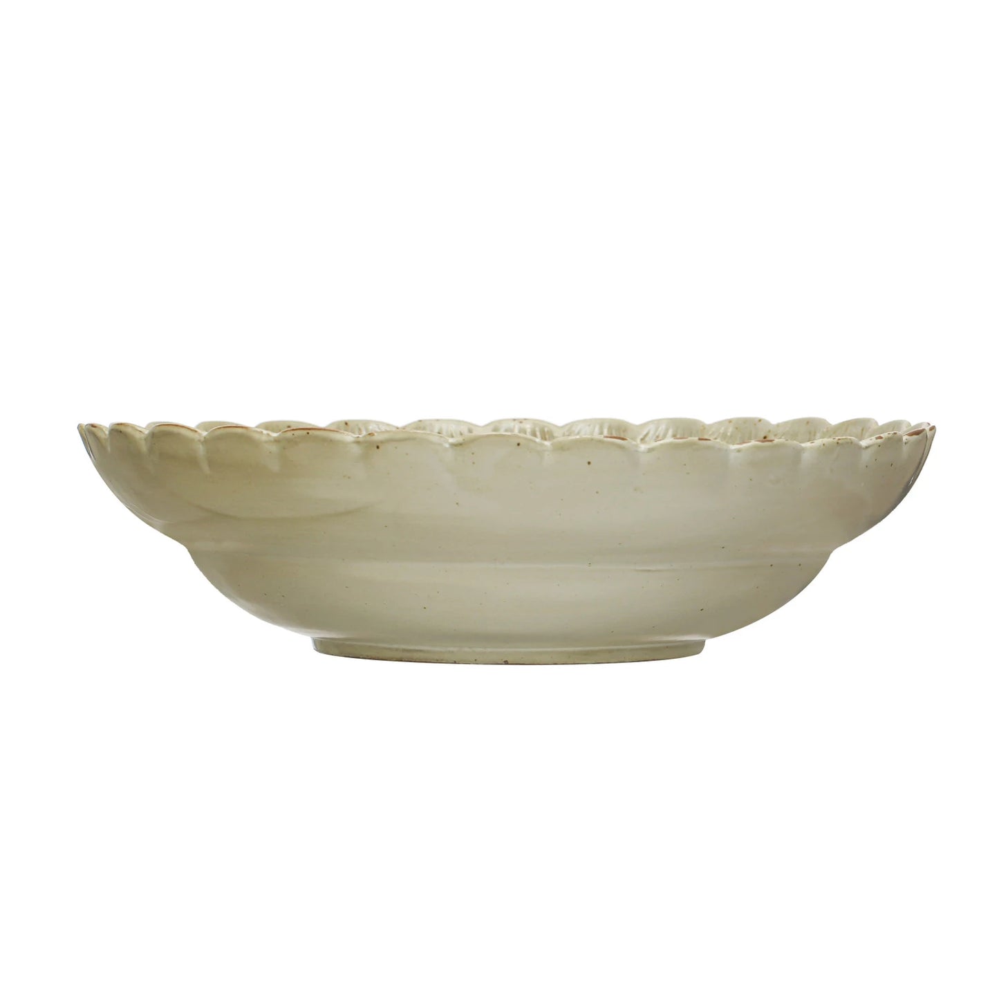 side view of scalloped bowl on a white background.