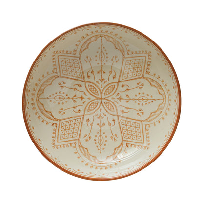top view of cream bowl with intricate orange pattern in the interior.