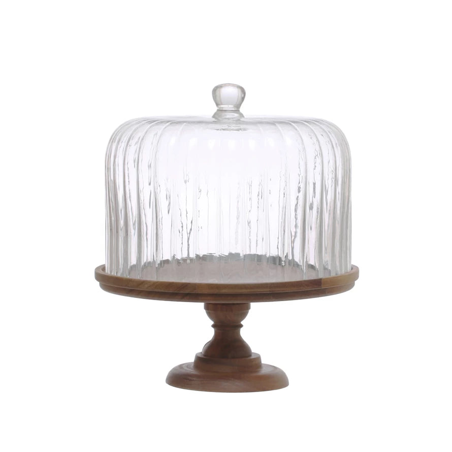 wooden pedestal with flute glass dome on it shown on a white background.