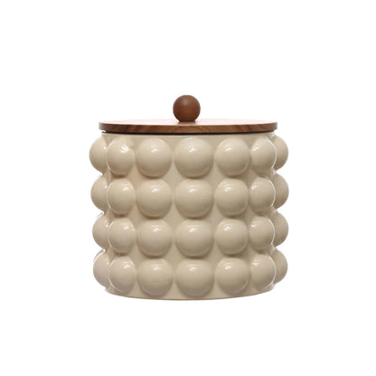 large raised dots and acacia wood lid stoneware canister displayed on a white background