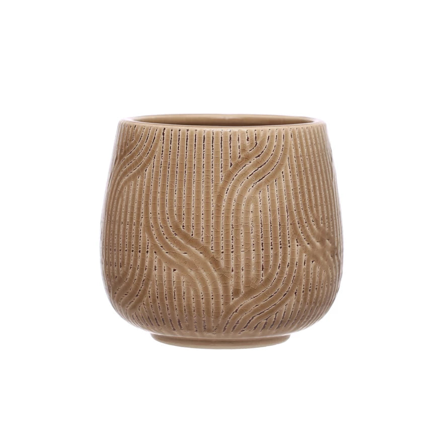 brown stoneware pot with line and swirl pattern on a white background.