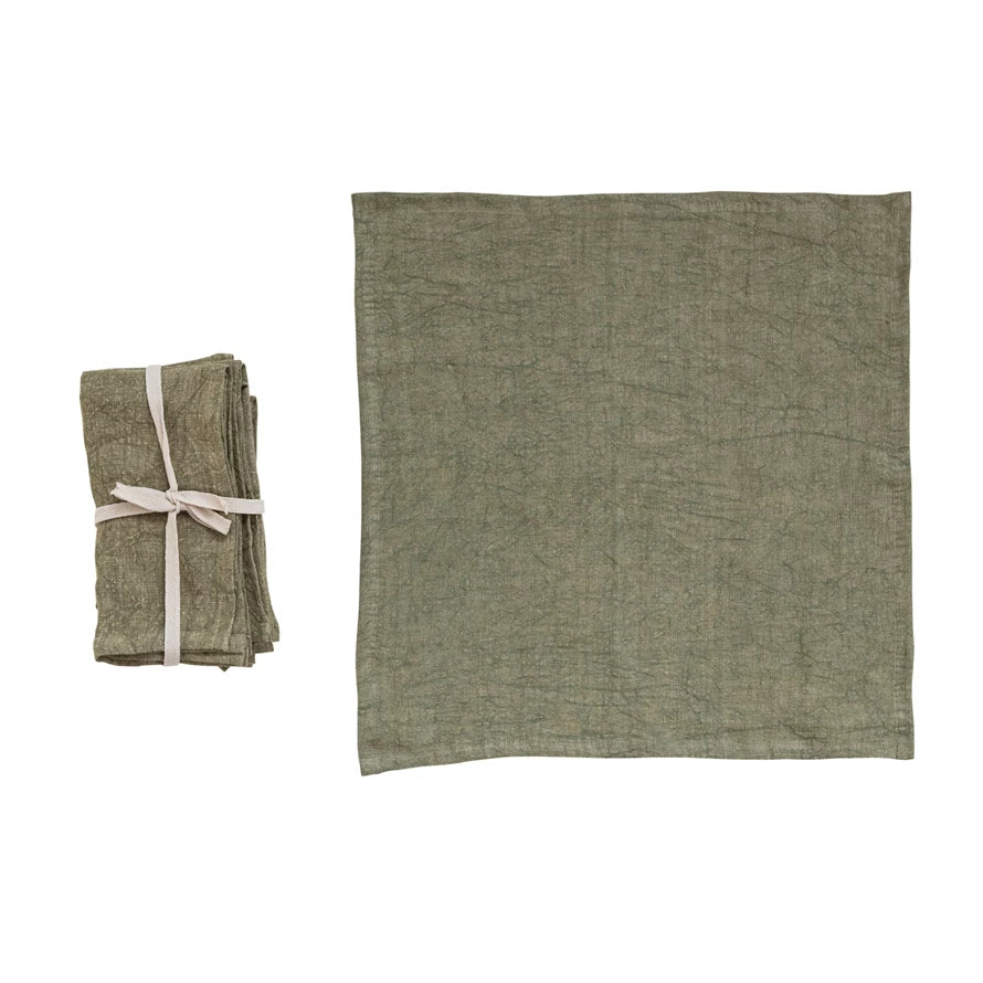 set of folded olive Stonewashed Linen Napkins tied with ribbon and one displayed laying flat on a white background