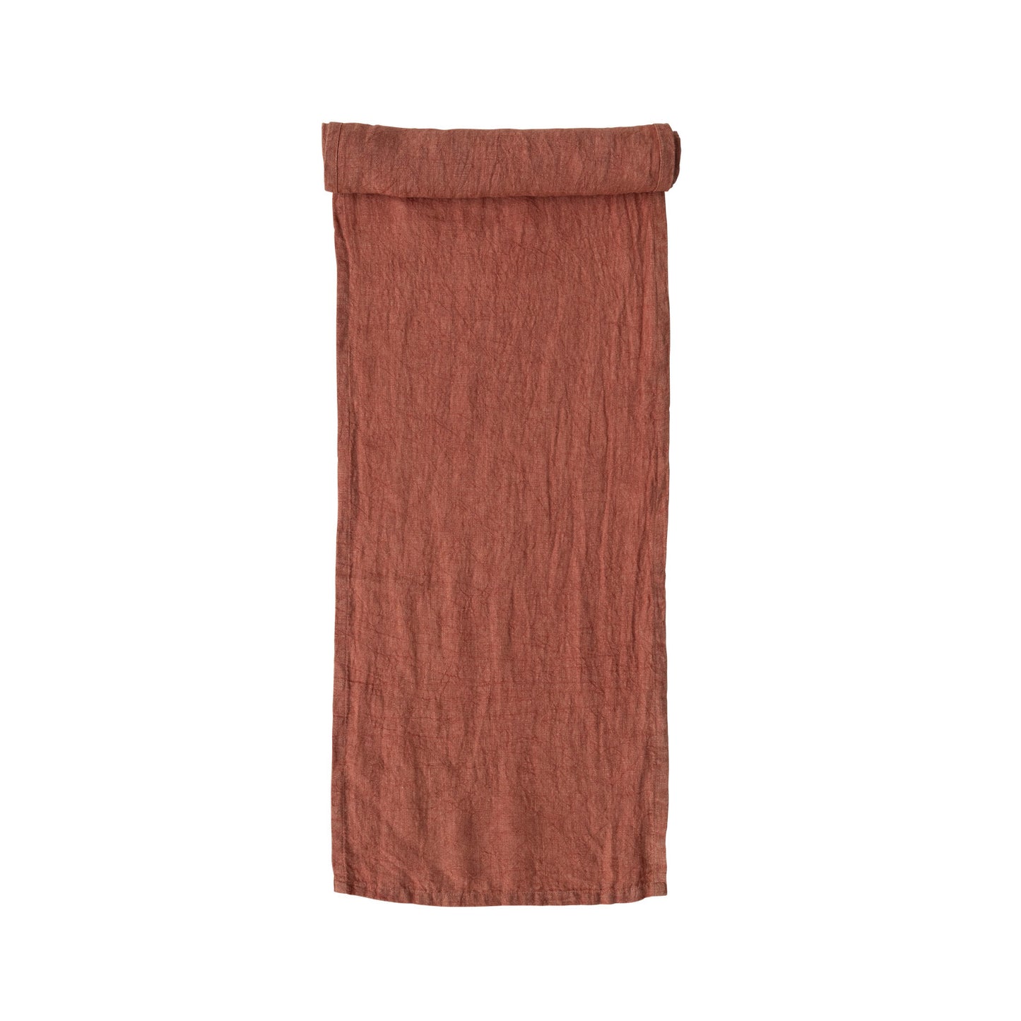 rust colored table runner partially rolled on one end.