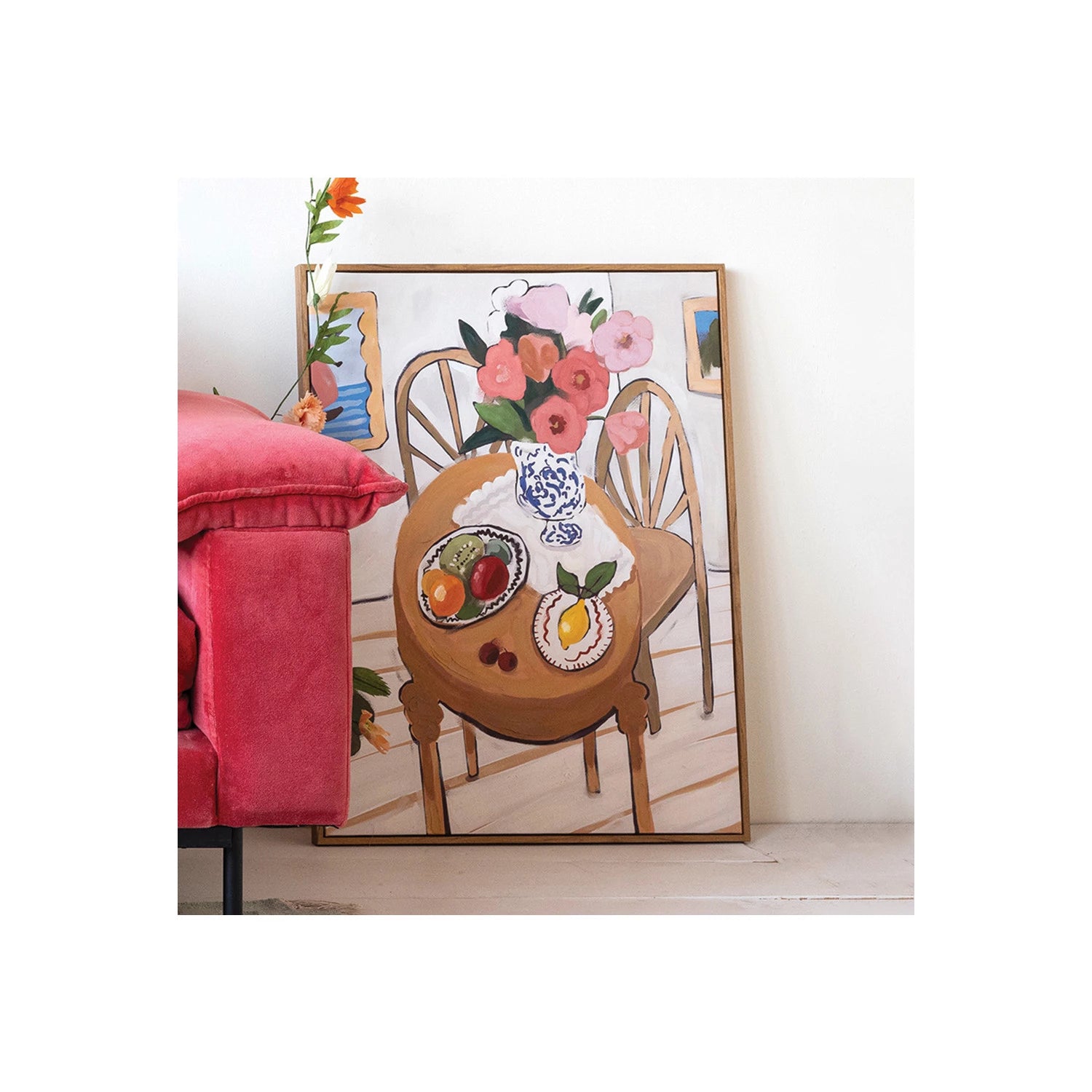 Kitchen Scene Canvas Art leaning against a wall near a fuchsia couch