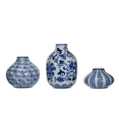 3 assorted blue and white patterned vases on a white background.