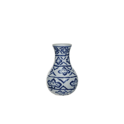 white bud vase with blue geometric pattern painted on it