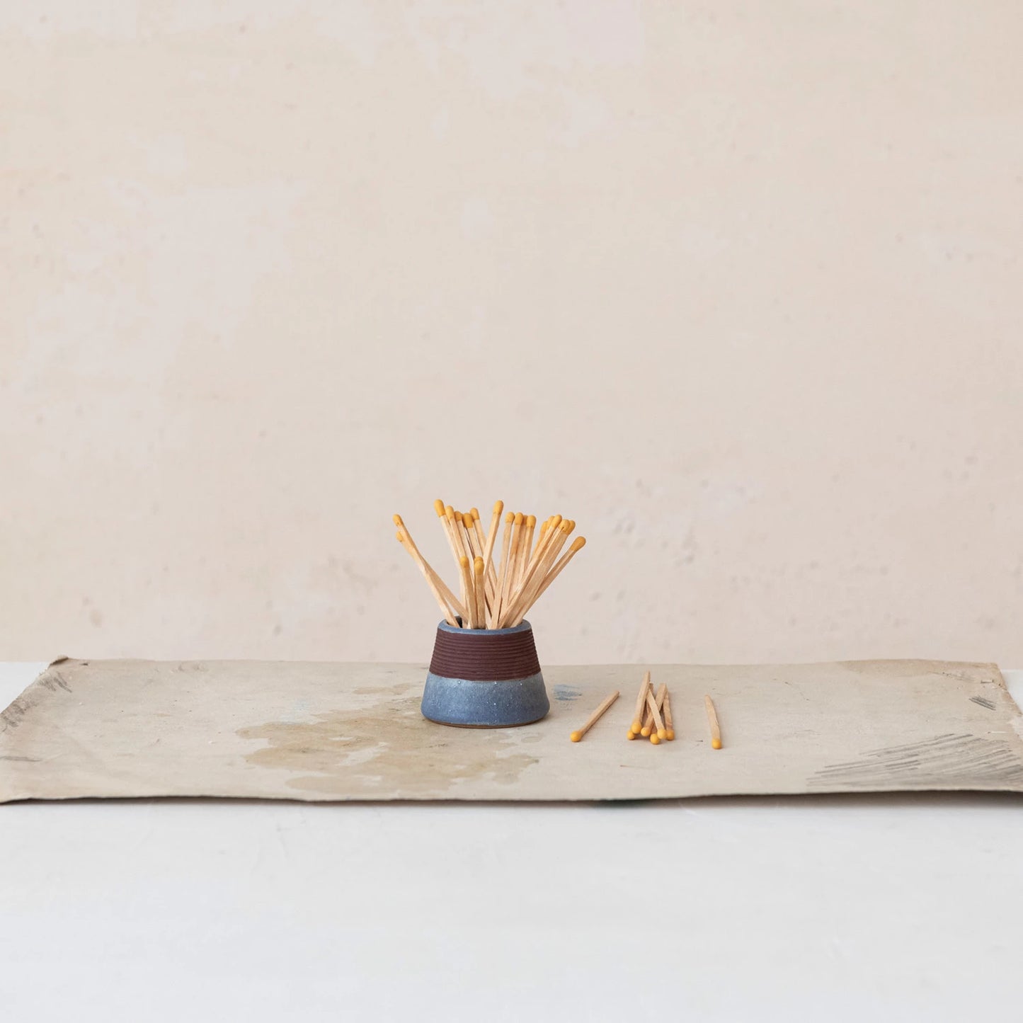 blue matchholder holding matches