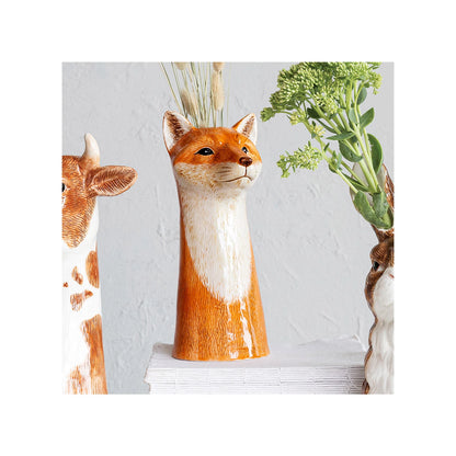 Fox-shaped vase with plants on a light gray background