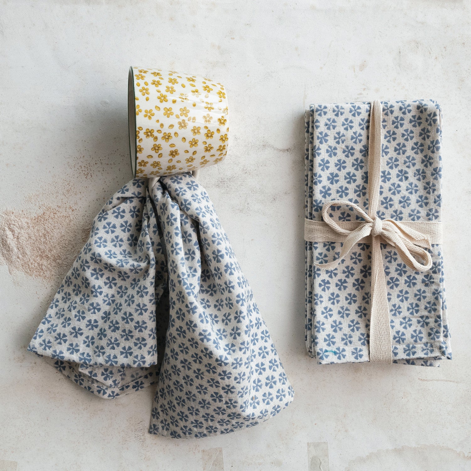 Napkin set next to a napkin using a mug as a napkin ring