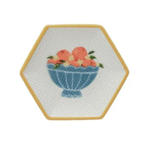 small hexagon dish with yellow rim and blue blow filled with oranges design in the center
