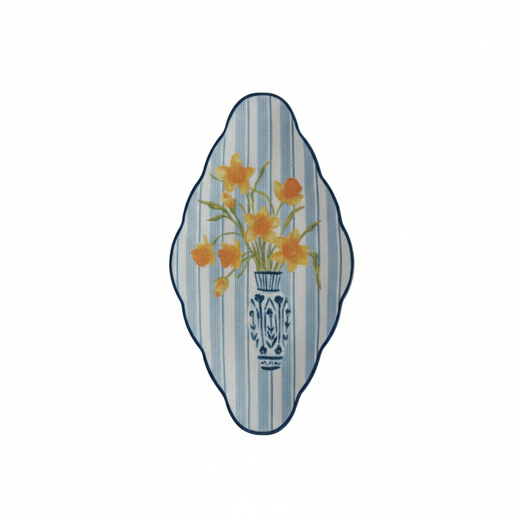 blue and white stripe platter painted with a design of daffodils in a vase on it