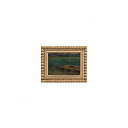 taupe wood beaded frame with seaside landscape in it
