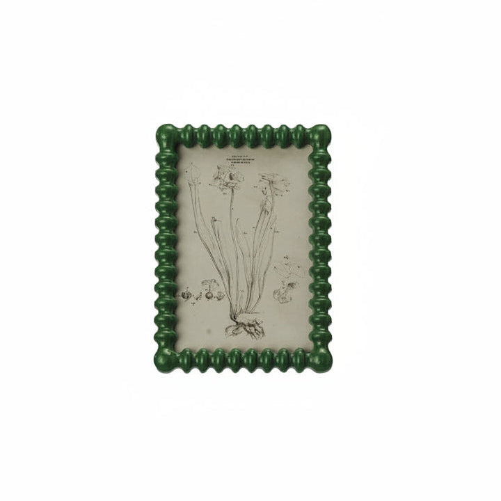 green spindle frame with image in a botanical study in it