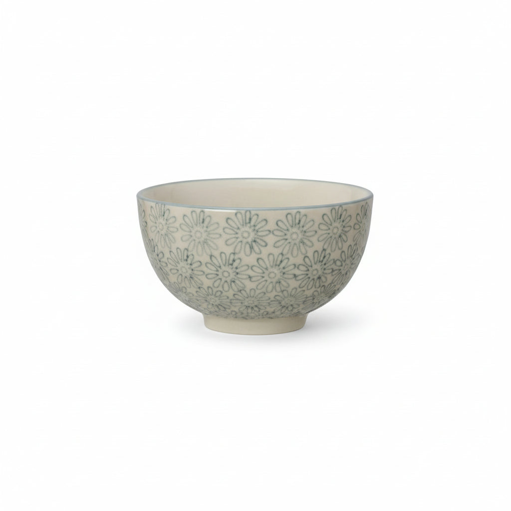 Ceramic bowl with light blue floral pattern on a white background