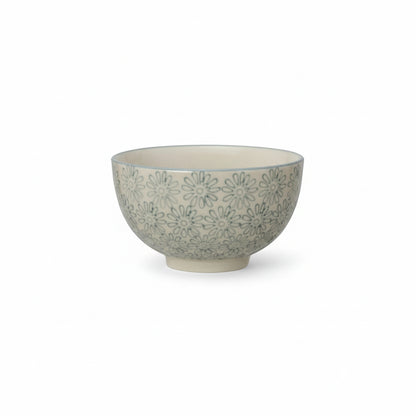 Ceramic bowl with light blue floral pattern on a white background