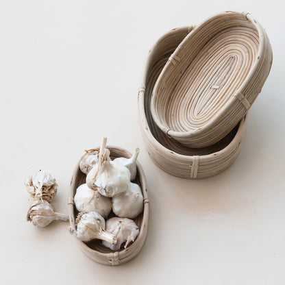 3 oval baskets, one has garlic bulbs in it