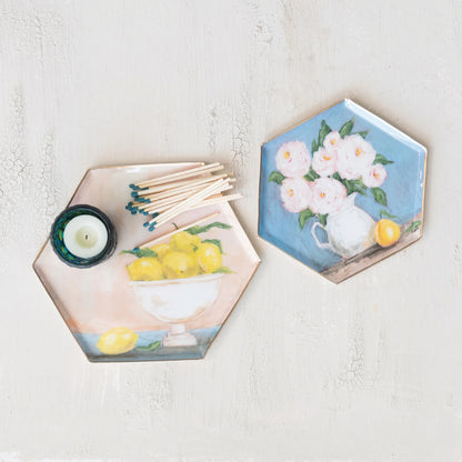 Hexagonal trays with floral and lemon designs on a light surface.