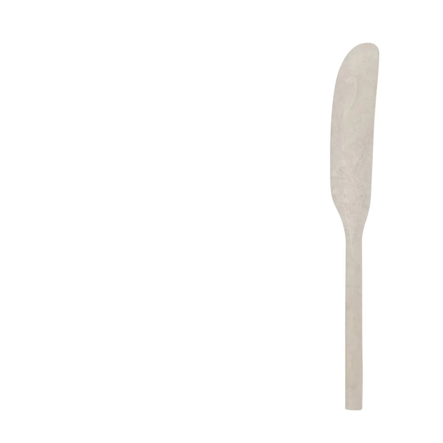 white marbled resin spreader on a white background