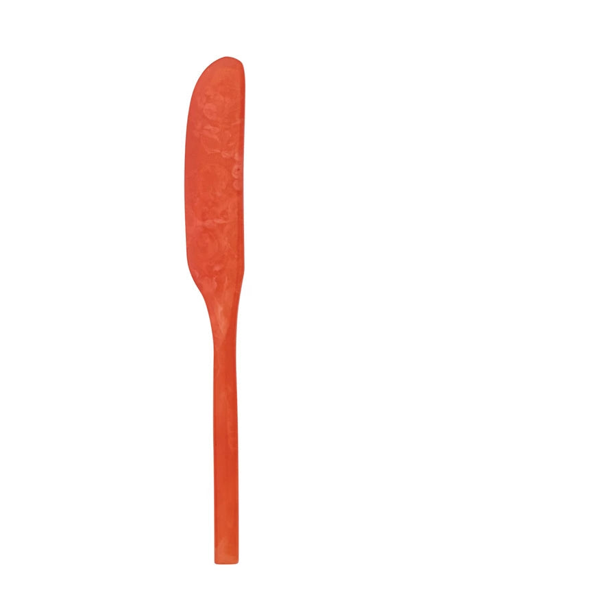 coral colored marbled resin spreader on a white background