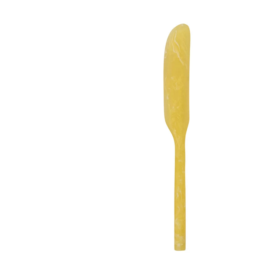 yellow marbled resin spreader on a white background
