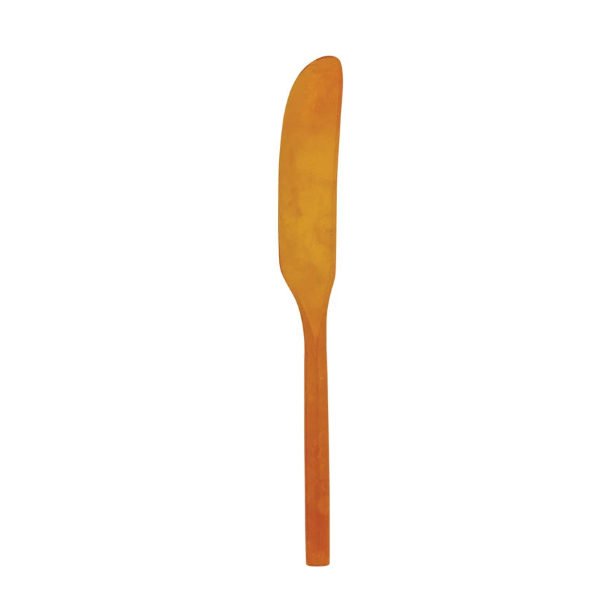 orange marbled resin spreader on a white background