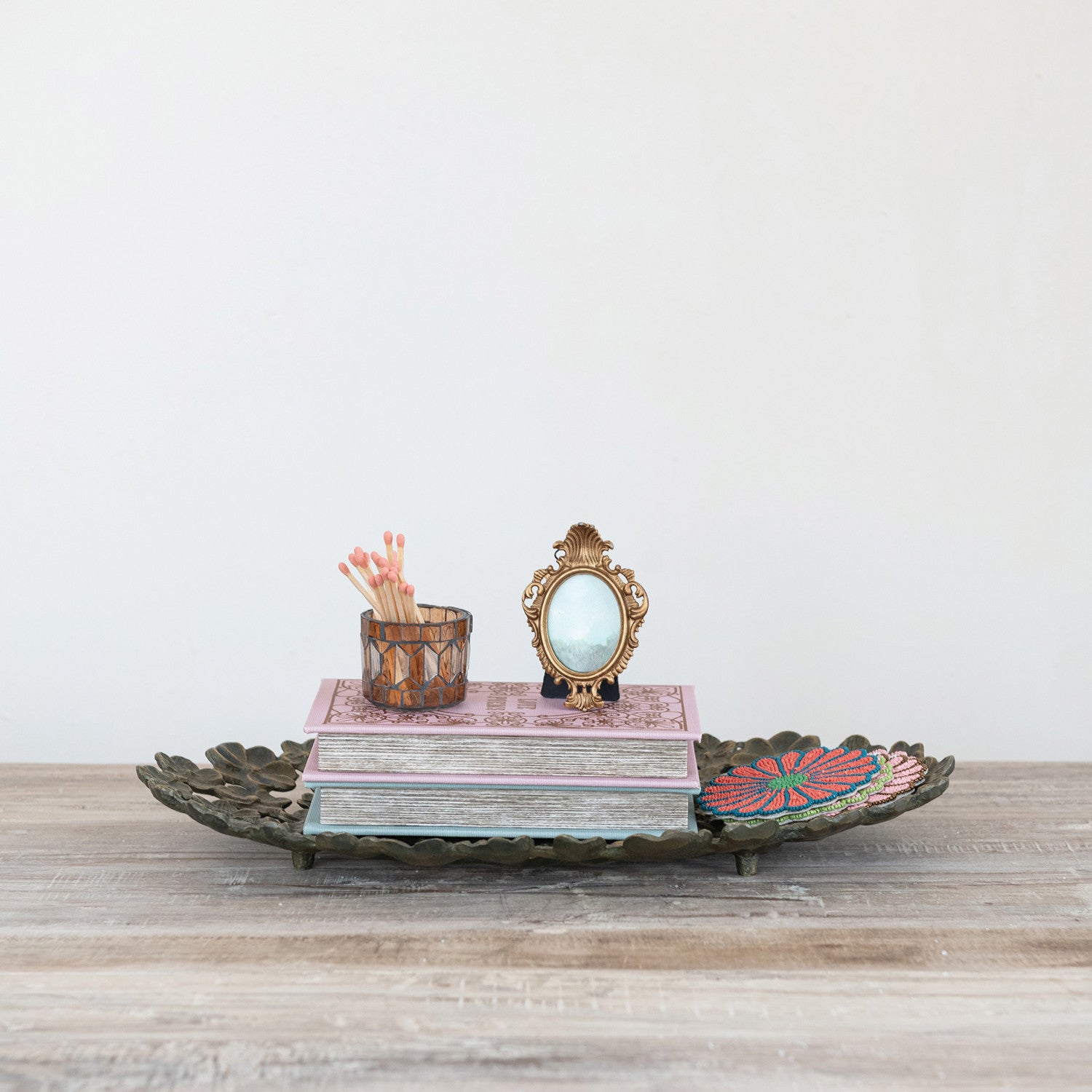 Antique Gold finish flower tray with decor items in it