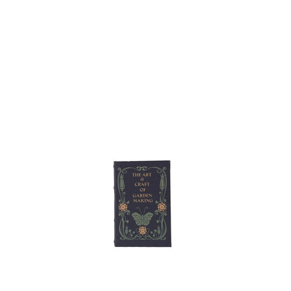 large navy book box with title 'the art and craft of garden making' with image of butterfly and flowers on it
