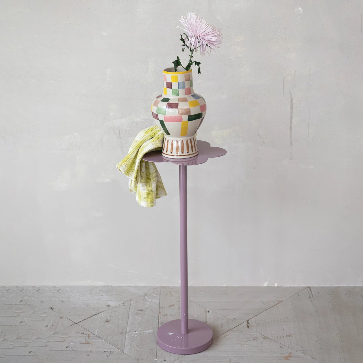 Colorful vase on a stand with a white background