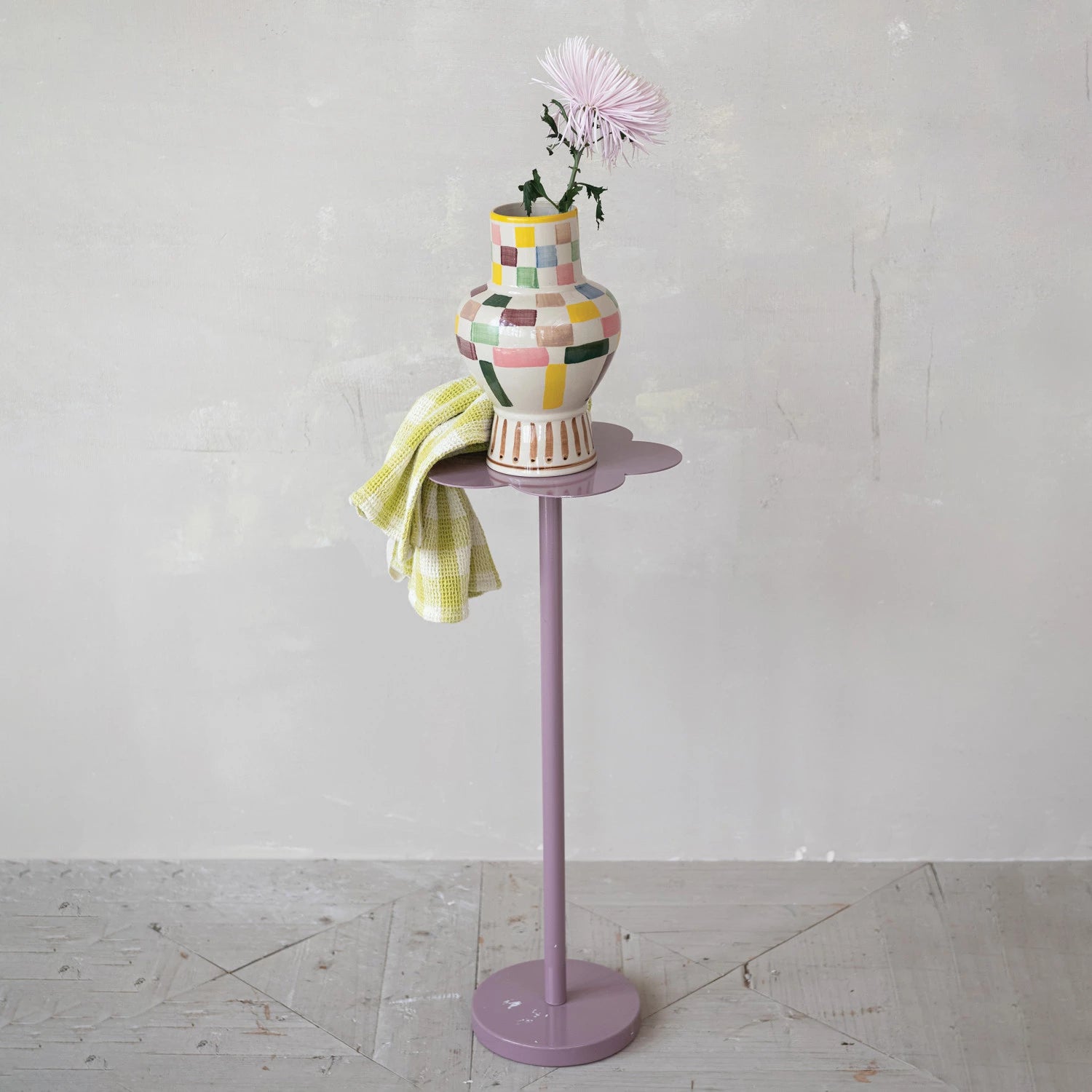 Colorful vase on a stand with a white background