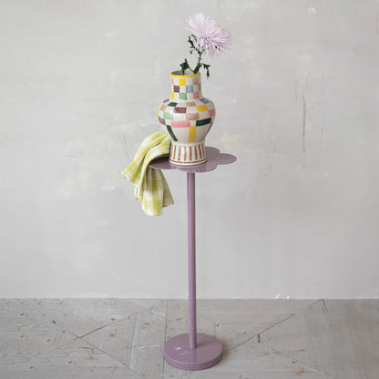 Colorful vase on a stand with a white background