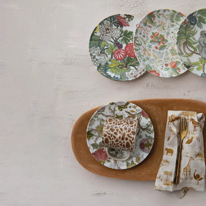 floral patterned plates arranged with other dinnerware on a plaster surface