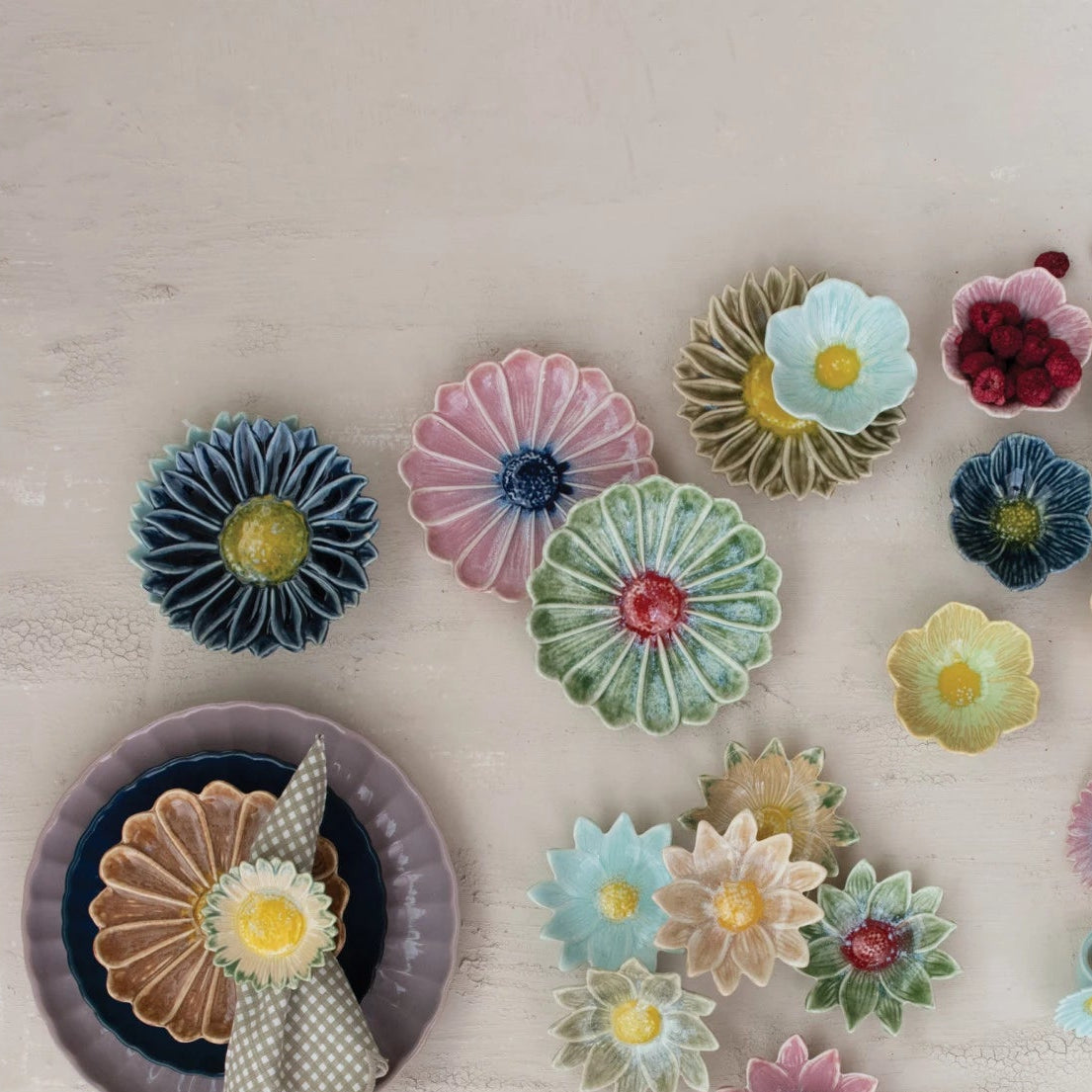 Colorful ceramic flower-shaped items on a light wooden surface