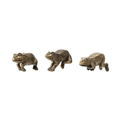 Three frog figurines on a white background