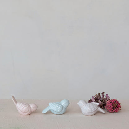 3 bird sitters on a decorated surface