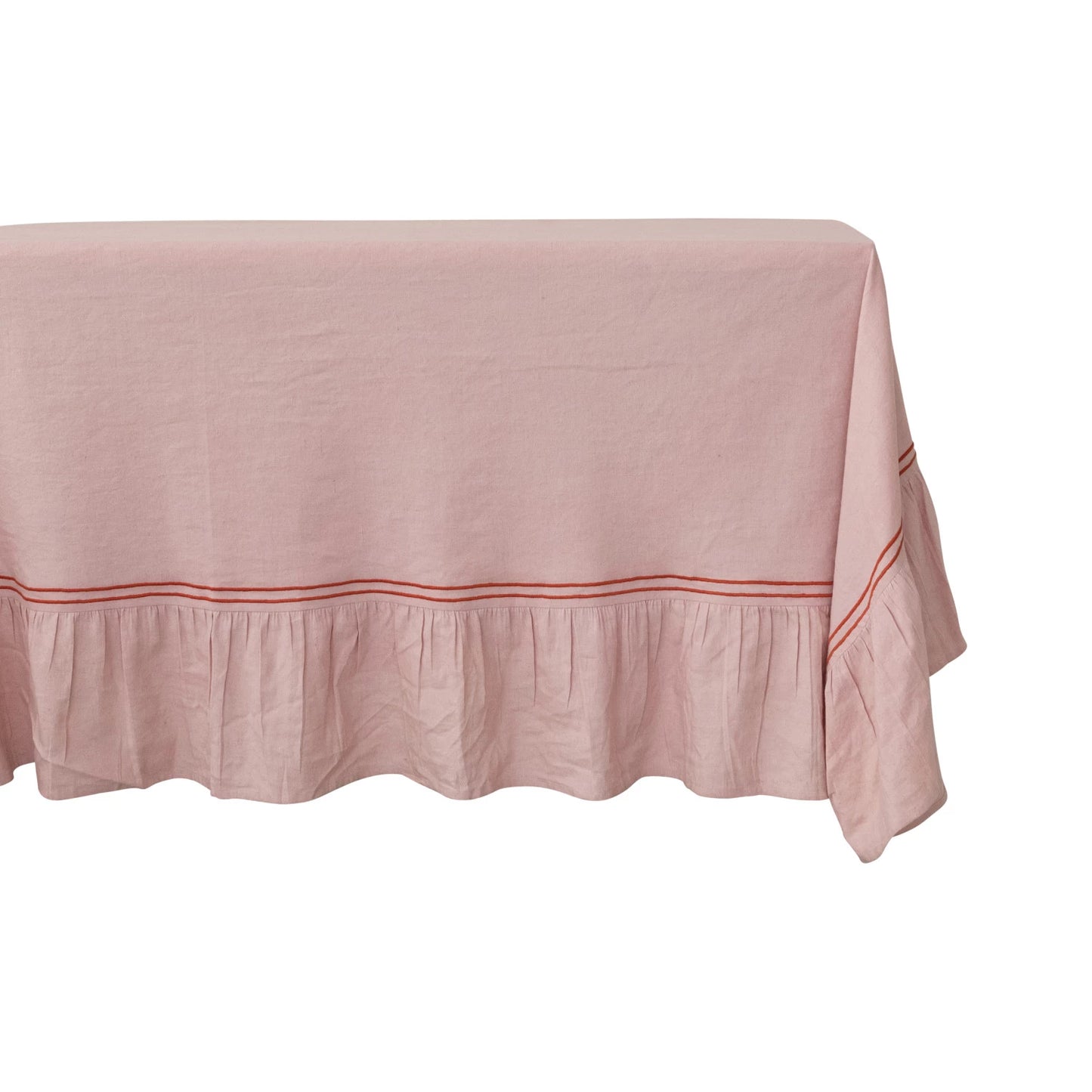 close-up of pink tablecloth with red trim on a table