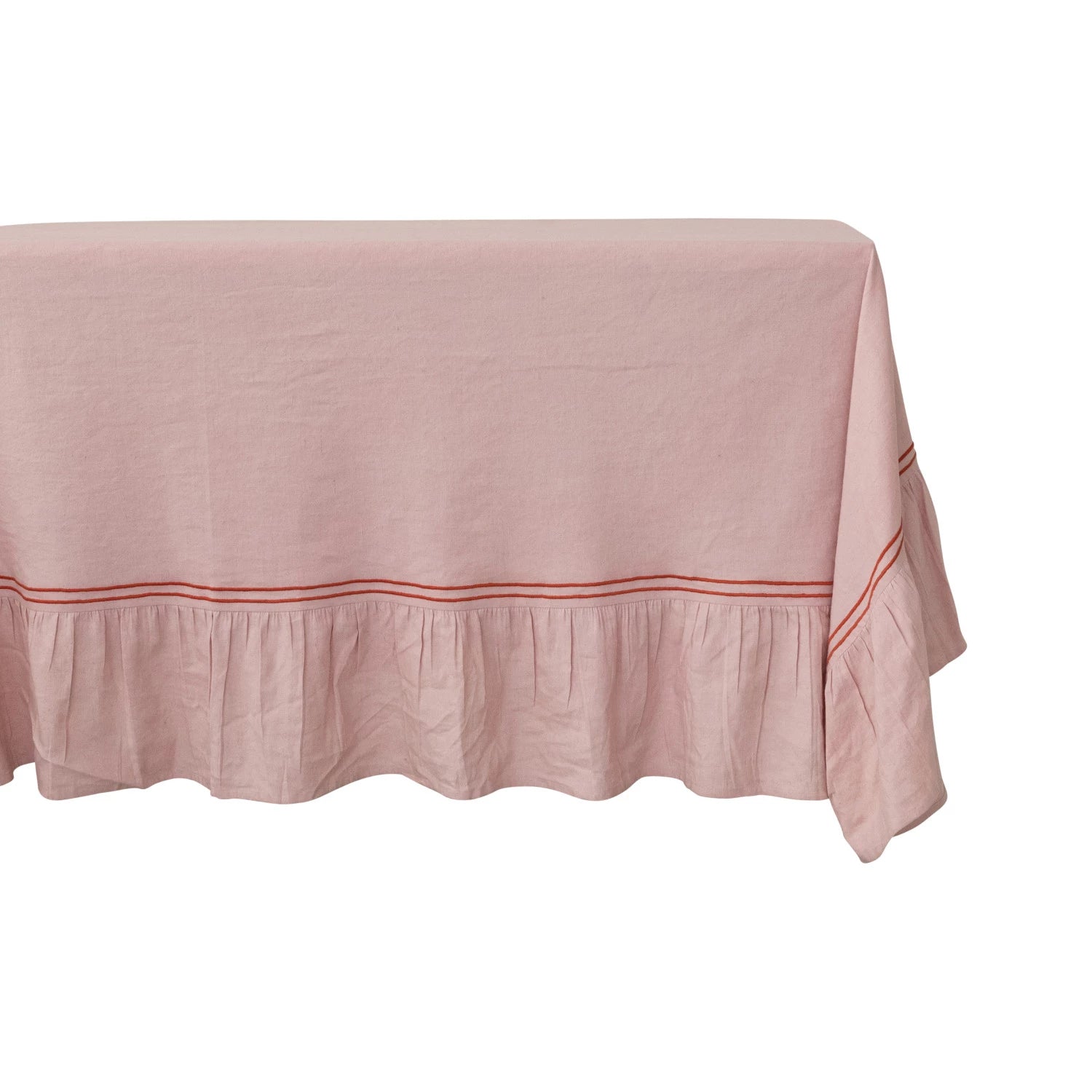 close-up of pink tablecloth with red trim on a table