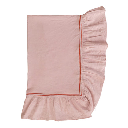 folded Pink ruffled tablecloth with red trim on a white background