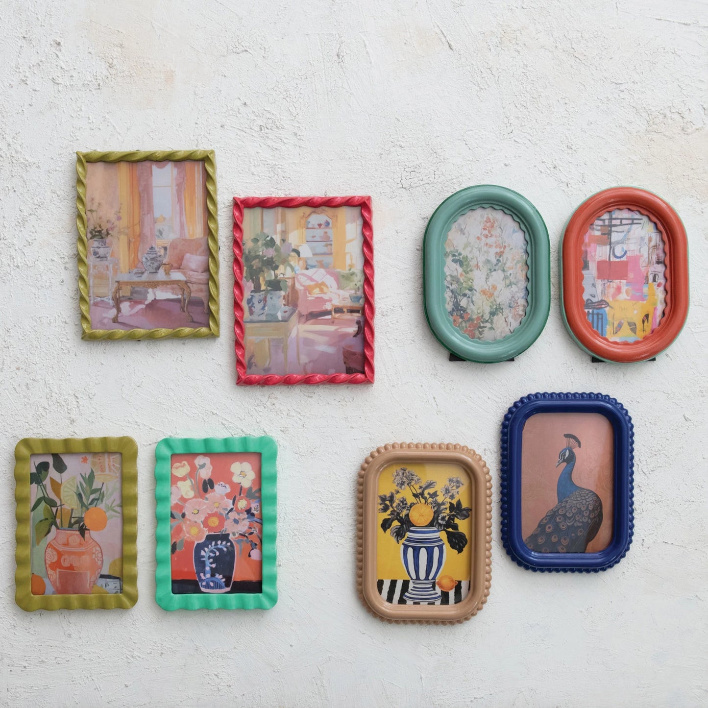 colorful picture frames with various designs on a white plaster wall.