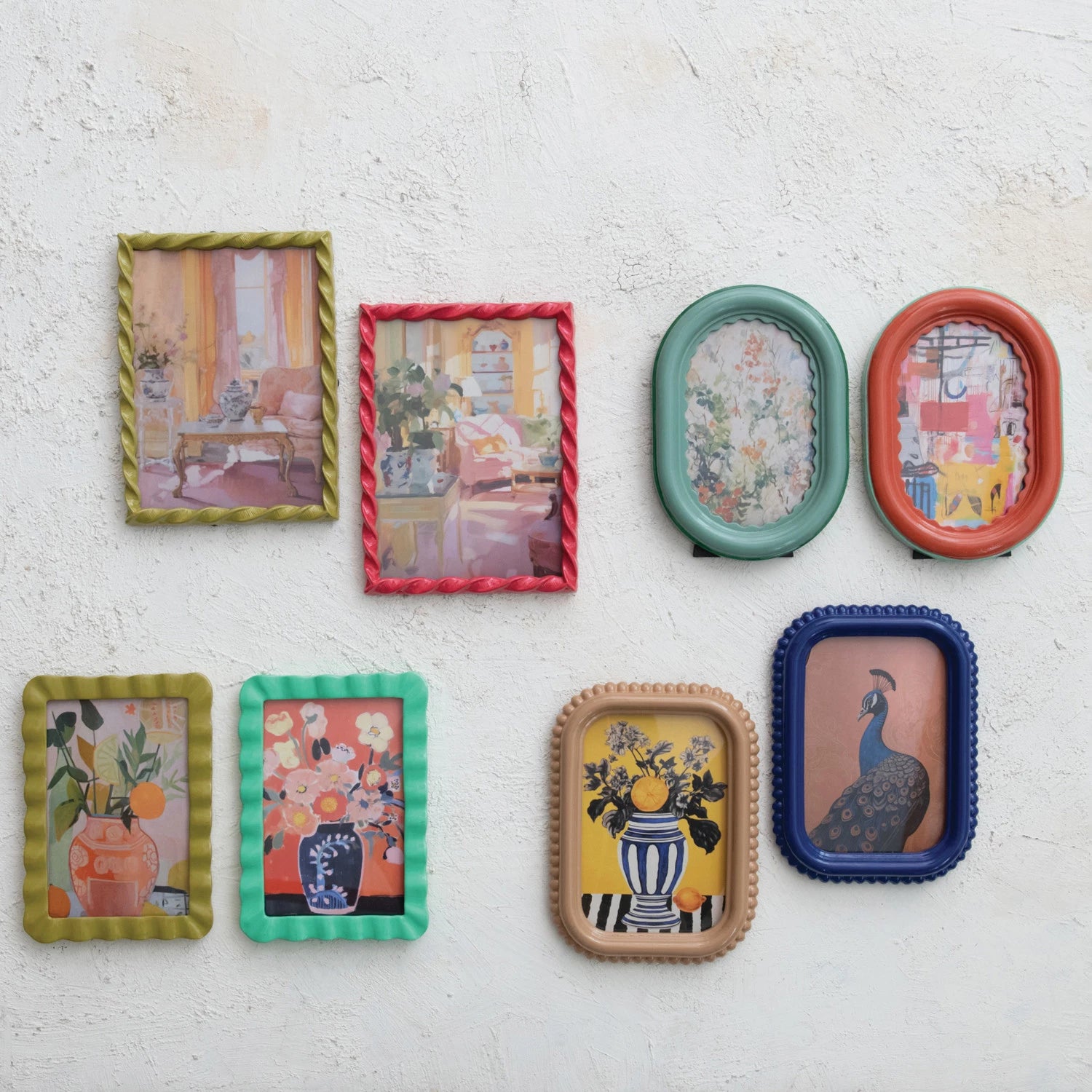 colorful picture frames with various designs on a white plaster wall.