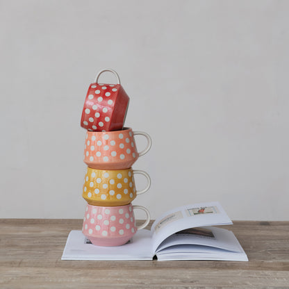 4 mugs stacked on top of each other on a book