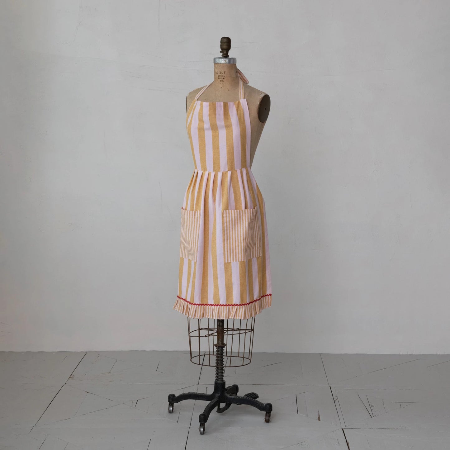 Striped apron on a mannequin against a grey background