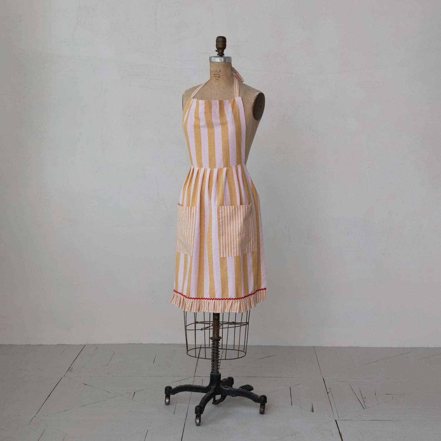 Striped apron on a mannequin against a grey background