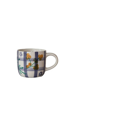 mug with floral and purple plaid patterns on a white background