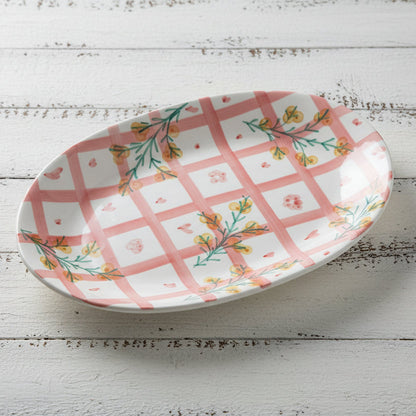 platter with pink plaid and floral design set on a white wooden table